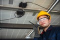 Engineer technical service checking solar panel while using walkie talkie for communicate with co worker to check the system of