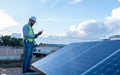 engineer technician checking output voltage level of inverter, electrician measuring power on solar panels Royalty Free Stock Photo