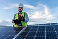 engineer technician checking output voltage level of inverter, electrician measuring power on solar panels Royalty Free Stock Photo