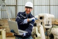 Engineer technician controlling robotic arms on computer laptop Royalty Free Stock Photo