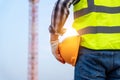 Engineer technician holding helmet in construction site and construction site worker background safety first concept Royalty Free Stock Photo