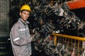 Engineer technician male worker work in old used machine part stock warehouse Royalty Free Stock Photo