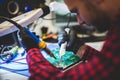 IT engineer technician repairing computer in electronics service shop