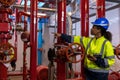 Engineer or technician work checking Fire suppression system and fire equipment. Engineer check red generator pump for water sprin Royalty Free Stock Photo