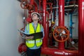 Engineer or technician work checking Fire suppression system and fire equipment. Engineer check red generator pump for water sprin Royalty Free Stock Photo