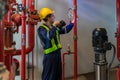 Engineer or technician work checking Fire suppression system and fire equipment. Engineer check red generator pump for water sprin Royalty Free Stock Photo