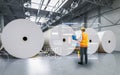 Engineer or technician work in paper factory with digital interface Royalty Free Stock Photo