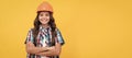 Engineer teenager girl. happy child with curly hair in construction helmet, contractor. Child builder in helmet