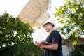 Engineer looking earth based astronomical radio telescope Royalty Free Stock Photo