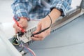 Engineer testing electronic component with oscilloscope