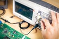 Engineer tests electronic components with oscilloscope in the service center