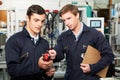 Engineer And Trainee Discussing Component In Factory Royalty Free Stock Photo