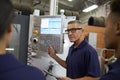 Engineer Training Apprentices On CNC Machine