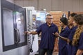 Engineer Training Apprentices On CNC Machine