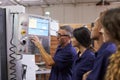 Engineer Training Apprentices On CNC Machine