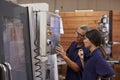 Engineer Training Female Apprentice On CNC Machine Royalty Free Stock Photo