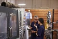 Engineer Training Female Apprentice On CNC Machine