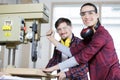 engineer training female apprentice to use cnc machine in factory Royalty Free Stock Photo