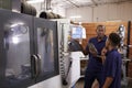 Engineer Training Young Male Apprentice On CNC Machine Royalty Free Stock Photo