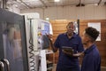 Engineer Training Young Male Apprentice On CNC Machine Royalty Free Stock Photo