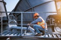 A engineer under checking the industry cooling tower air conditioner is water cooling tower air chiller HVAC of large industrial b Royalty Free Stock Photo