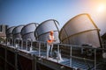 A engineer under checking the industry cooling tower air conditioner is water cooling tower air chiller HVAC of large industrial b Royalty Free Stock Photo