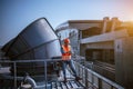 A engineer under checking the industry cooling tower air conditioner is water cooling tower air chiller HVAC of large industrial b Royalty Free Stock Photo