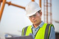 Engineer under inspection and checking construction process, Engineer man in waistcoats and hardhats and with documents in Royalty Free Stock Photo