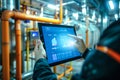 An engineer uses a tablet to control smart factory automation software. Generative AI