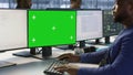 Engineer using green screen computer, working in server farm Royalty Free Stock Photo