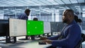 Engineer using green screen computer, working in server farm Royalty Free Stock Photo