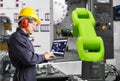 Engineer using laptop computer control automatic robotic hand machine tool with CNC machine in automotive industry, Industry 4.0 Royalty Free Stock Photo