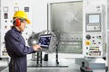 Engineer using laptop computer control automotive CNC machine in automotive industry, Smart factory concept