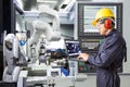 Engineer using computer for maintenance automatic robotic industry Royalty Free Stock Photo