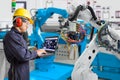 Engineer using laptop computer maintenance automatic robotic hand machine tool in automotive industry, Industry 4.0 concept Royalty Free Stock Photo