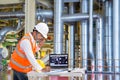 Engineer using laptop computer for maintenance equipment in thermal power plant factory Royalty Free Stock Photo