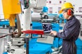 Engineer using laptop computer maintenance robot grip automotive workpiece position, Smart factory concept