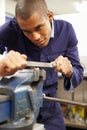 Engineer Using Metal File On Factory Floor