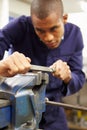 Engineer Using Metal File On Factory Floor