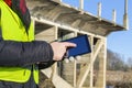 Engineer using tablet near the bridge in winter