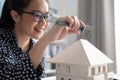 Engineer using Vernier caliper to measuring architectural model Royalty Free Stock Photo