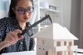 Engineer using Vernier caliper to measuring architectural model Royalty Free Stock Photo