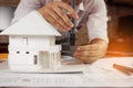 Engineer using vernier caliper to measuring house model Royalty Free Stock Photo