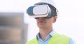 Engineer in VR glasses visualizing building plan at construction site, using interface of future, tracking shot