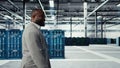 Engineer walking in data center facility, doing inspection on hardware tech Royalty Free Stock Photo