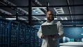 Engineer walking in data center using AI automation during maintenance session Royalty Free Stock Photo