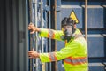 Engineer wear PPE checking inside container as Chemical spill in the container shipping industry