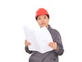 An engineer wearing a hard hat is looking at the drawings