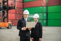 Engineer wearing a hardhat standing cargo at the container yard and Check container integrity Before exporting products abroad