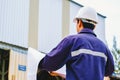 Engineer with white safety helmet holding project plan at construction outdoor site background Royalty Free Stock Photo